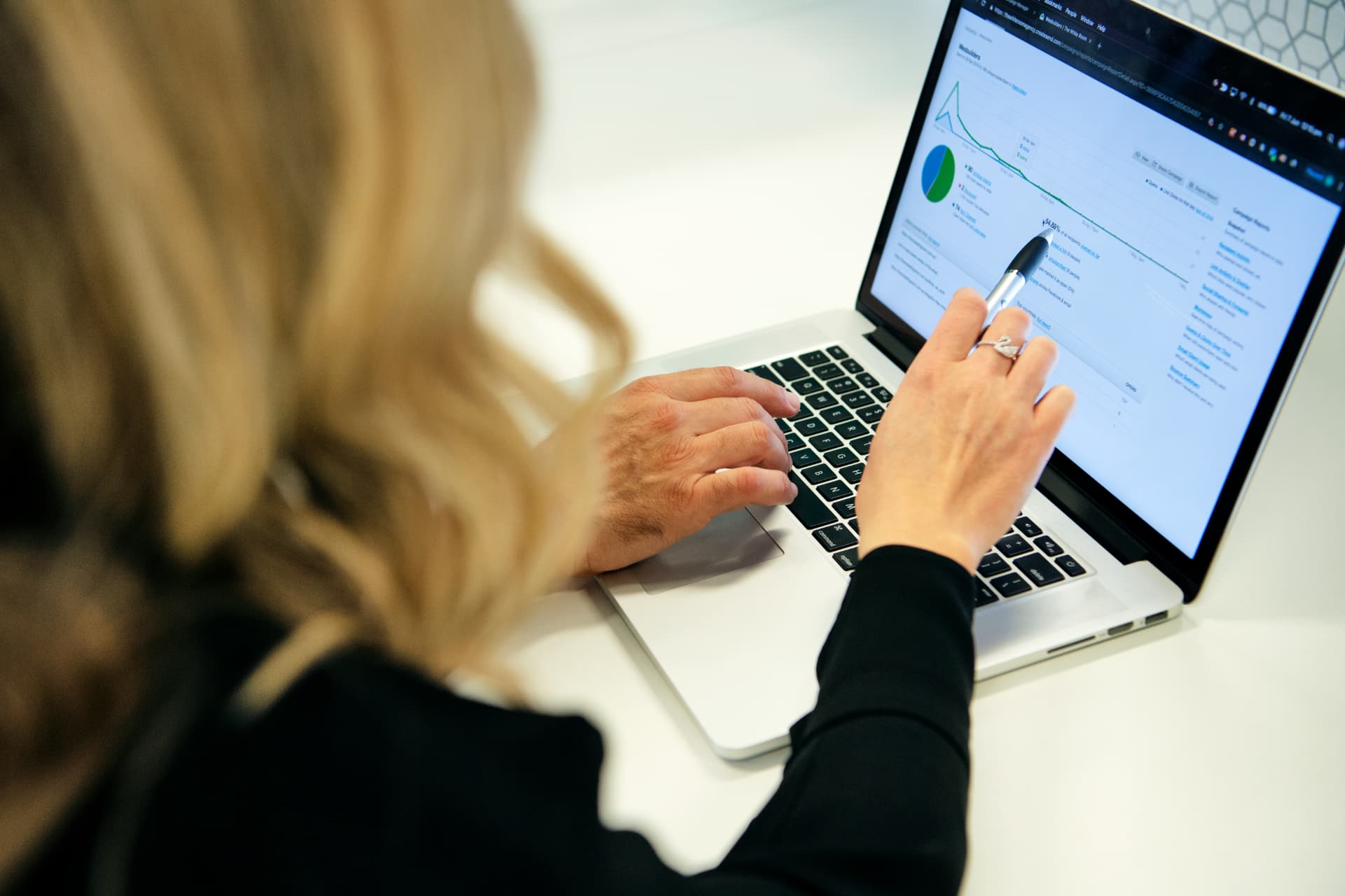 A marketing professional reviewing analytics on a laptop
